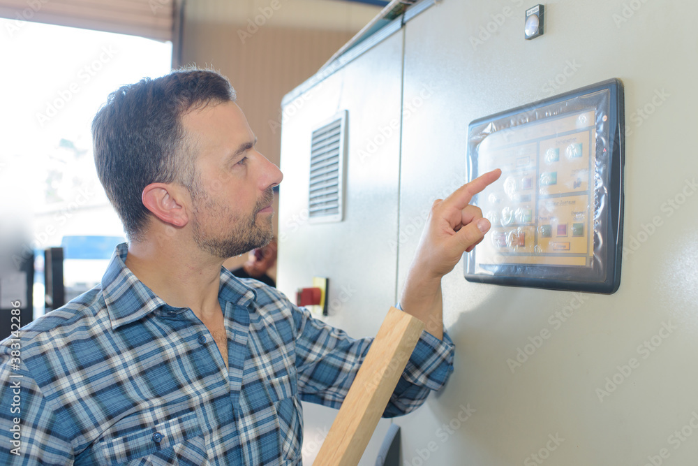 a man changing the machine setting a man changing the machine setting