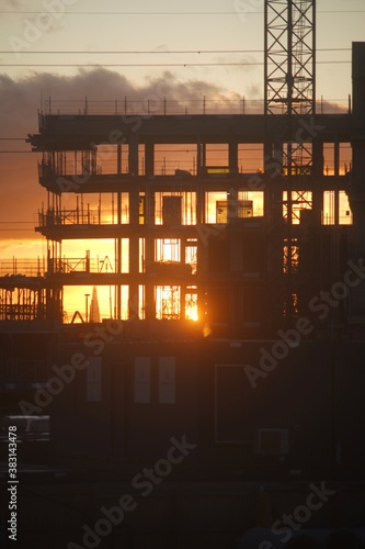 sun is setting through a contrition site in london  © Akash