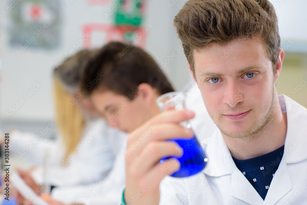 young man showing his experiment young man showing his experiment
