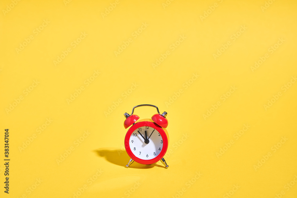 Red retro alarm clock on yellow background. Minimal time concept. Christmas or New year eve. Red retro alarm clock on yellow background. Minimal time concept. Christmas or New year eve.