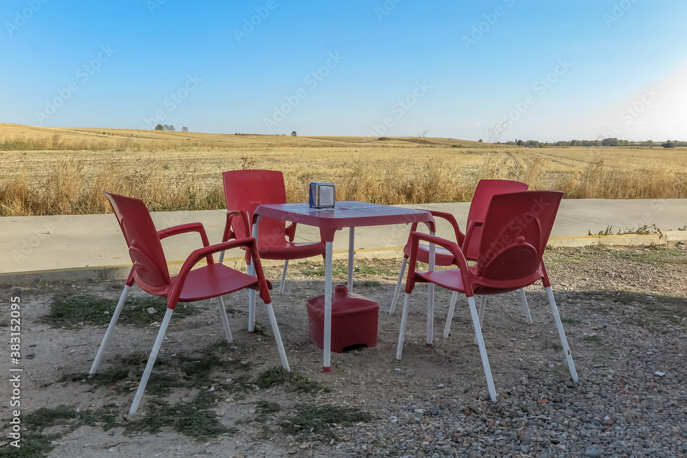 Plastic table and chairs in front of a hostel in the small town of Calzadilla de la Cueza, province of Palencia, autonomous community of Castile and Leon, Spain