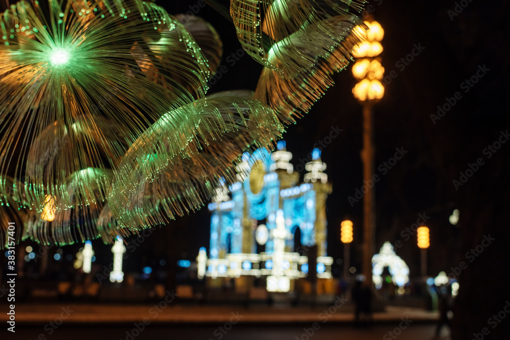 festive christmas lights in the city, decorative fiber optics lights on dark background