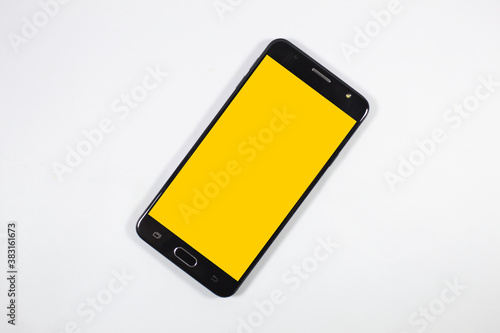 Принти на полотні Smartphone com tela amarela e fundo branco