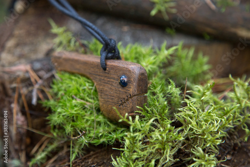 wooden amulet around the neck