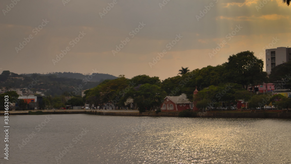 panoramic with the evening light reflecting in the calm waters of Taboao lake.