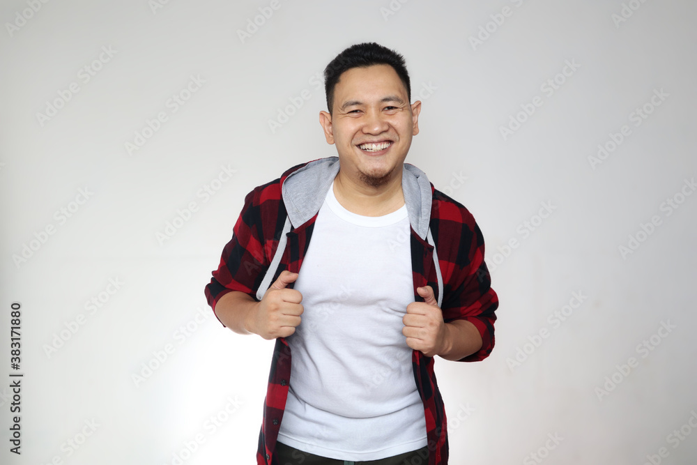 Young happy successful Asian man smiling at camera. Confident good looking positive person, over white