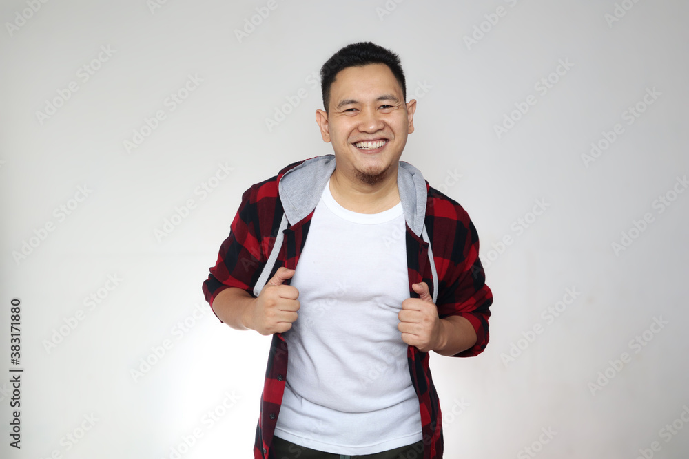Young happy successful Asian man smiling at camera. Confident good looking positive person, over white Young happy successful Asian man smiling at camera. Confident good looking positive person, over white