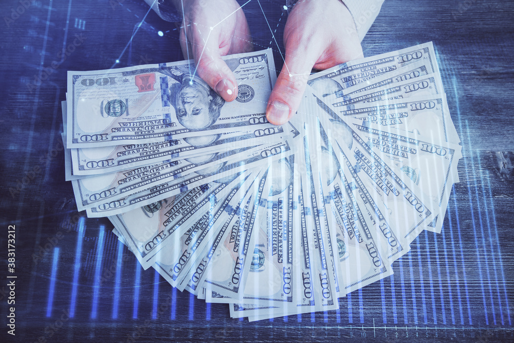 Multi exposure of financial graph drawing hologram and USA dollars bills and man hands. Analysis concept. Multi exposure of financial graph drawing hologram and USA dollars bills and man hands. Analysis concept.