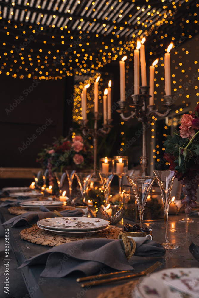 Christmas table with candles, flowers and fruits