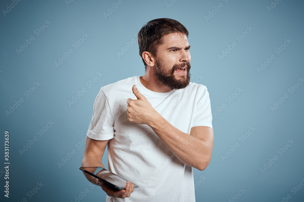 A guy with a tablet on a blue background and in a white T-shirt sensor Monitor Model A guy with a tablet on a blue background and in a white T-shirt sensor Monitor Model