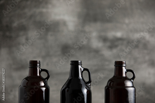 beer growler bottles for craft beer with white space for a copy over a grey background