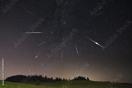 Fotografie Perseid meteor shower with farm building