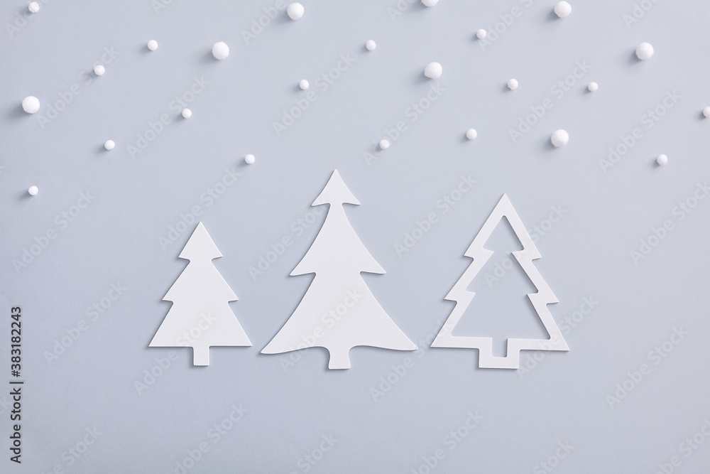 Obraz premium White fir tree shape with snowfall on pastel background