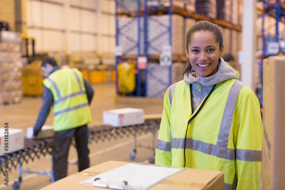 Fototapeta premium Portrait smiling female worker in distribution warehouse