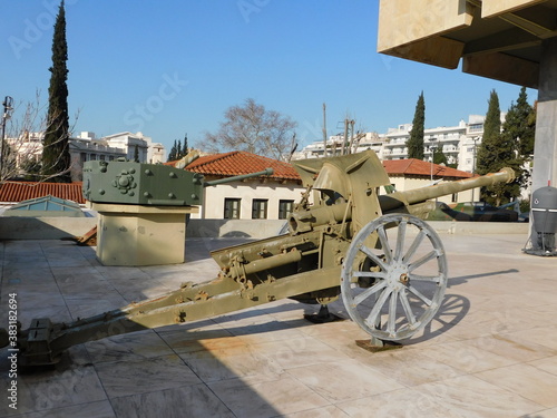 An old, 1925, French, Schneider 85mm field gun, and a British, Cromwell tank turret, in Athens, Greece photo