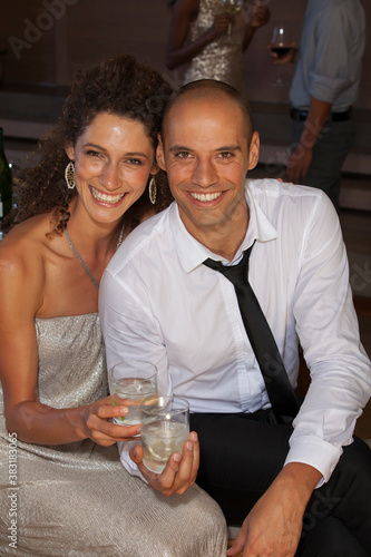 Canvas Print Portrait happy couple drinking cocktails at party