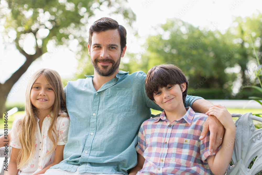 Fototapeta premium Portrait happy father and children on bench