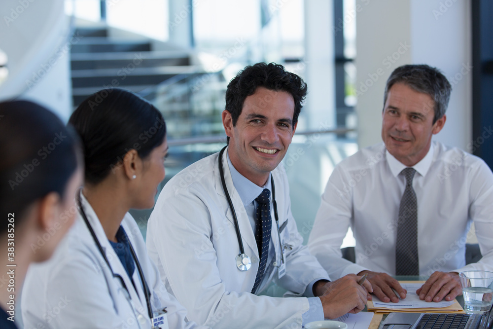 Fototapeta premium Portrait confident doctors talking in hospital meeting