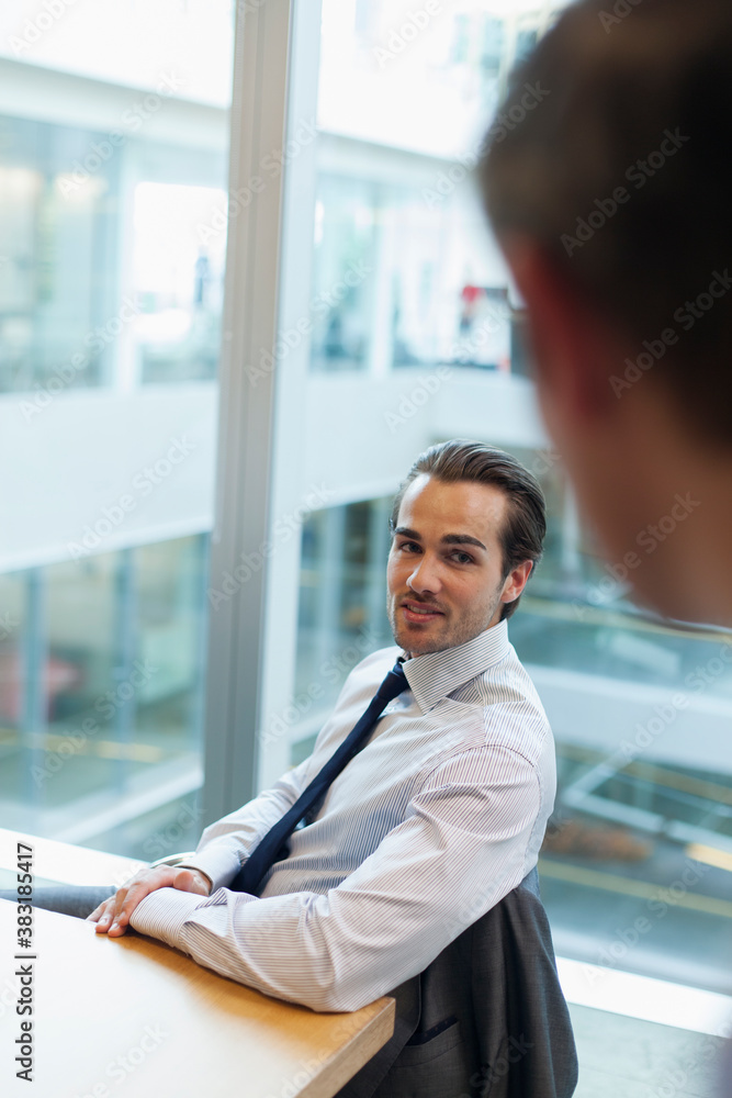 Fototapeta premium Corporate businessman talking with colleague in office