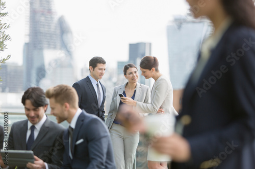 Corporate business people talking and working in city park