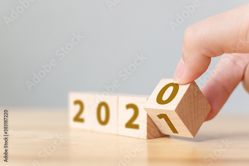 New year 2020 change to 2021 concept. Hand flip over wood cube block