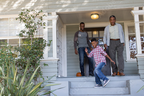 Fotografie Multi-generation men on front stoop