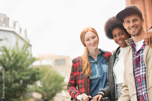 Portrait happy young friends in city