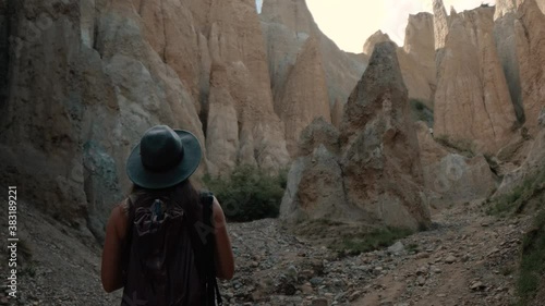 Woman hiker looking at clay rock formations