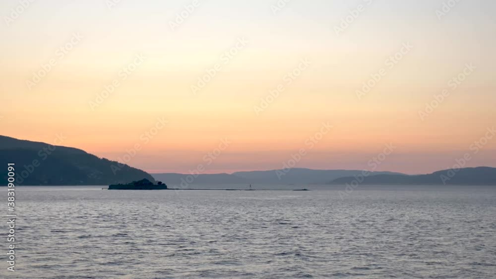 Sunset at sea with an ancient monastery island Munkholmen in foreground Norway Sunset at sea with an ancient monastery island Munkholmen in foreground Norway