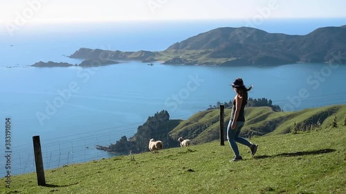 Woman walking on beautiful coastal hillside by the ocean