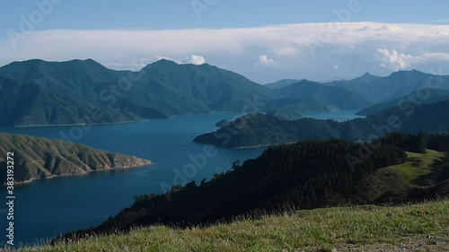 Sweeping view of green mountain hills in the ocean