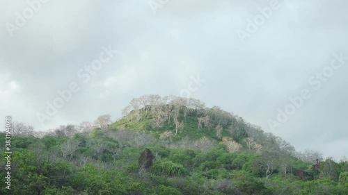Timelapse of Clouds over Mountain with Green Desert Vegetation on Espumilla Beach, Santiago Island, Galapagos