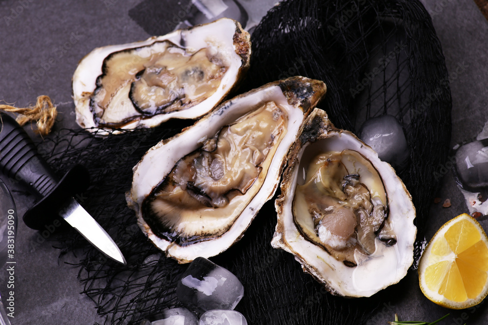 Fresh oysters on a black stone background Fresh oysters on a black stone background