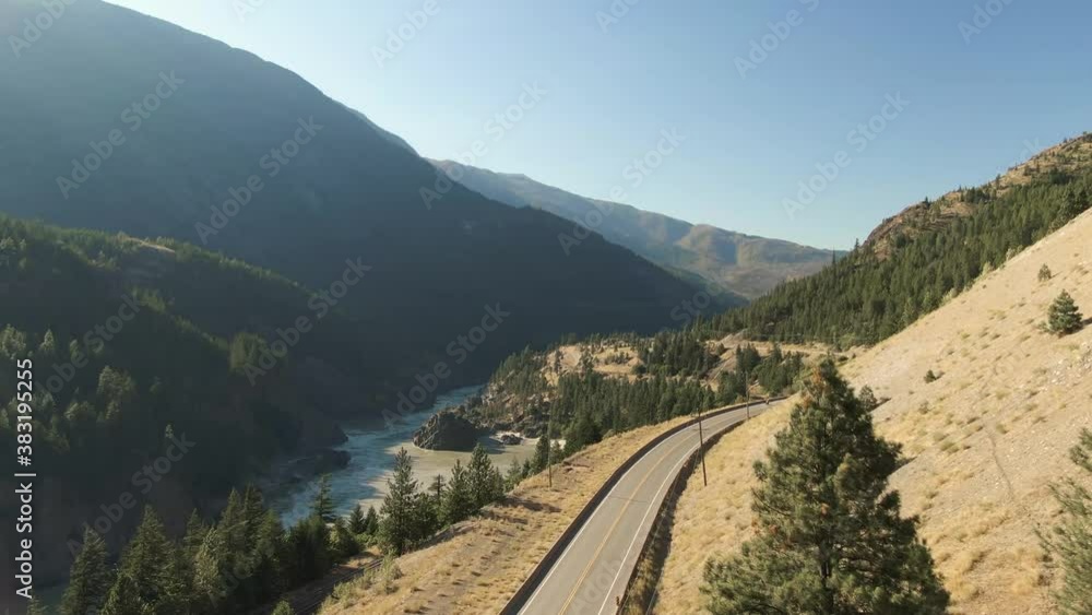 Beautiful View of Canadian Nature and a Scenic Road, Trans-Canada Hwy, during sunny summer day. Aerial Drone Shot. Near Hells Gate, BC, Canada. Beautiful View of Canadian Nature and a Scenic Road, Trans-Canada Hwy, during sunny summer day. Aerial Drone Shot. Near Hells Gate, BC, Canada.