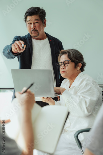 Old elderly senior ceo and secretary asking team for opinion.