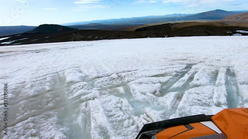 View of frozen landscape of Icelandic glacier from camera mounted on front of 4x4 buggy car. Water drops accumulated on the camera.