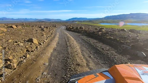 Breathtaking view from camera mounted on front of buggy car running at high speed on dirt road amidst deserted land.