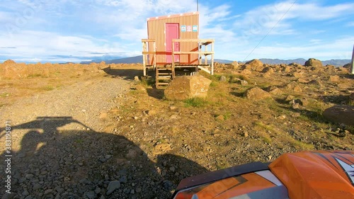 Buggy car parked on the side of a dirt road and shadow of drivers having a conversation.