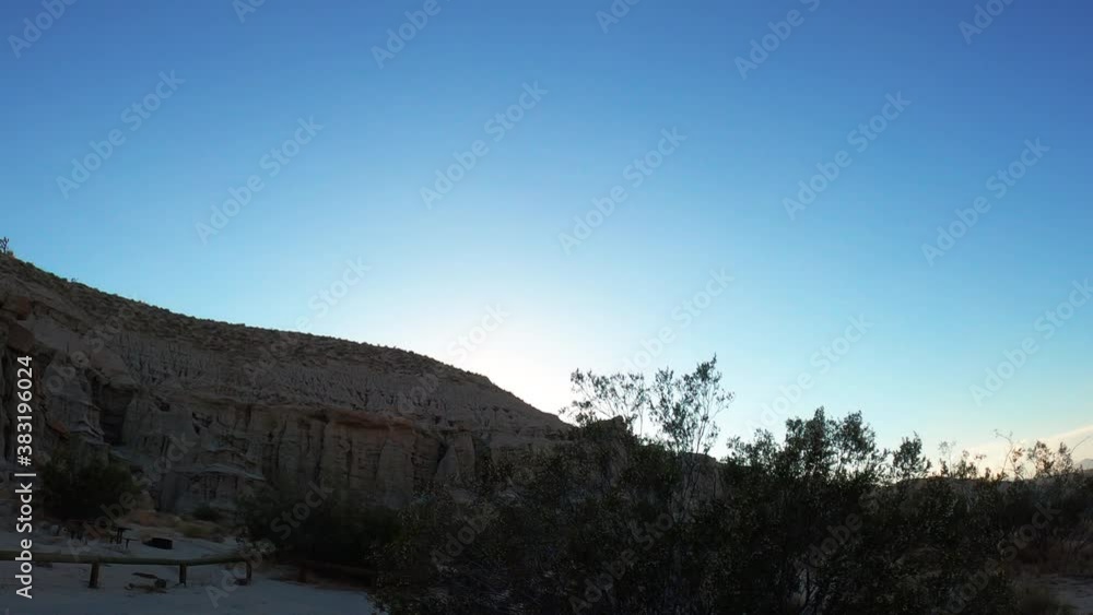 The cliffs at RedRock Canyon State Park a dusk - panoramic sliding view as seen from a car window The cliffs at RedRock Canyon State Park a dusk - panoramic sliding view as seen from a car window