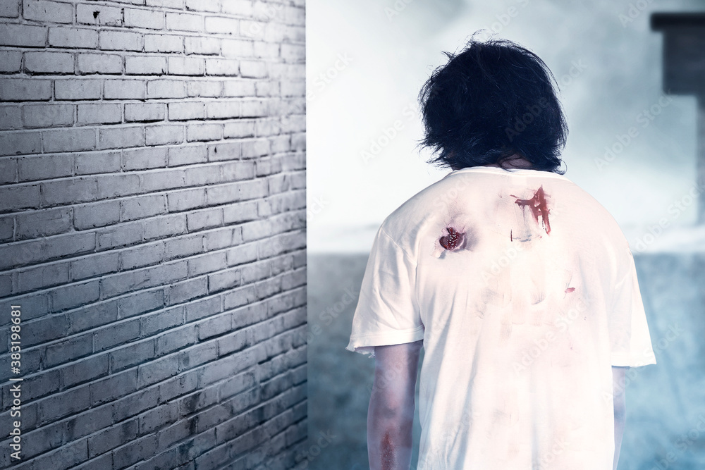 Obraz premium Scary zombie with blood and wound on his body standing