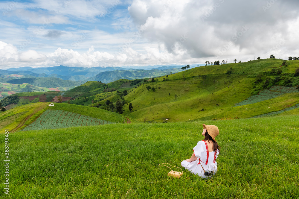Young woman feel relaxing on green grass mountain