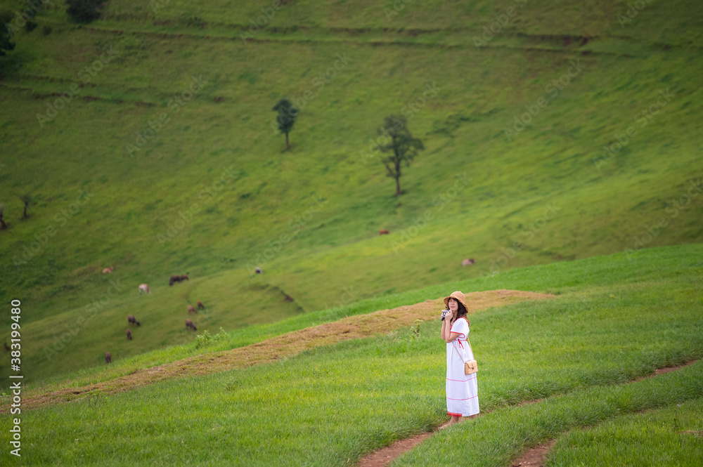 Young woman feel relaxing on green grass mountain Young woman feel relaxing on green grass mountain