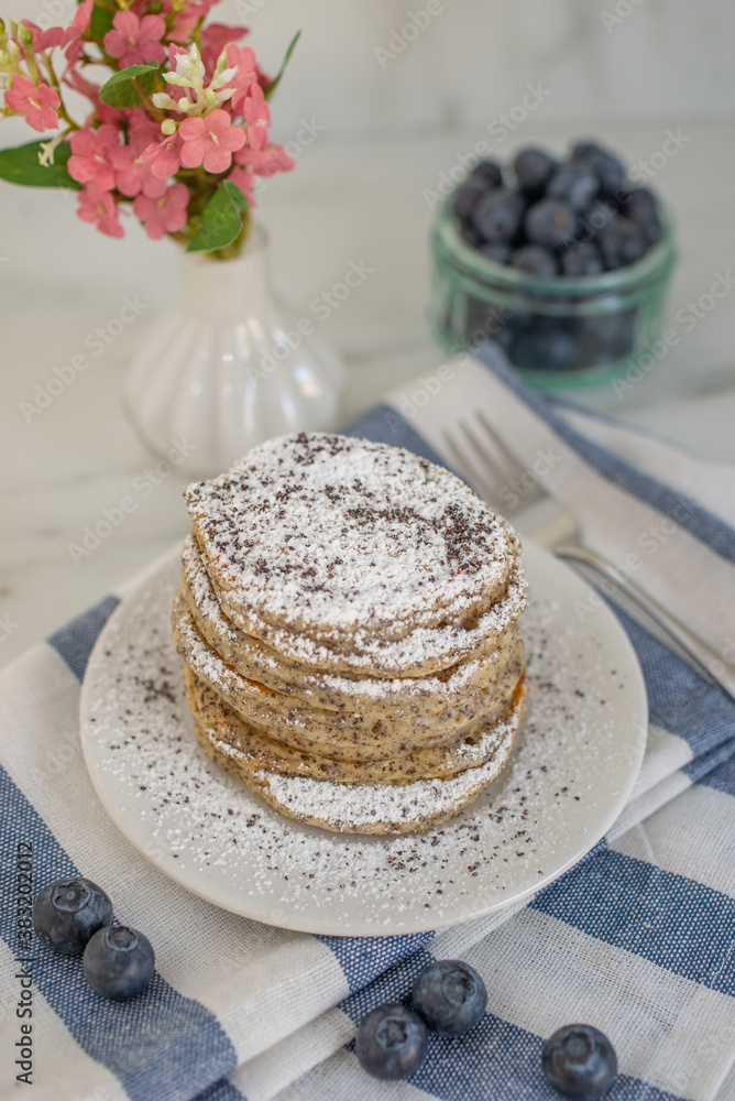 Home made lemon pancakes with poppy seeds on a breakfast table Home made lemon pancakes with poppy seeds on a breakfast table