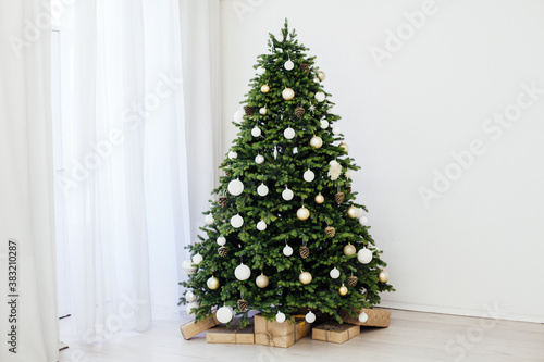 Winter Christmas tree pine with gifts new year decor garland interior of the holiday home December
