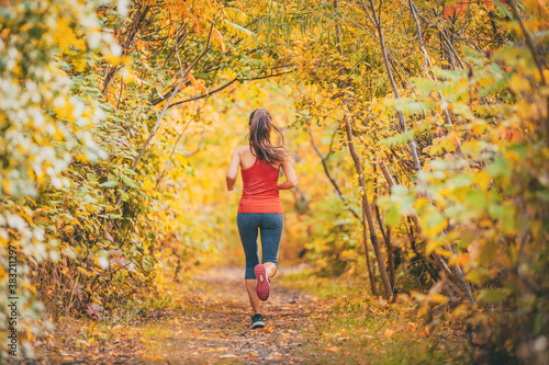 Konstfotografi Outdoor sports active lifestyle runner running in forest woods foliage with autumn yellow leaves
