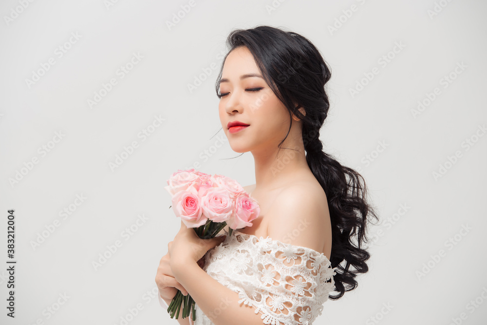 Portrait of elegant woman with flower bouquet over white background. Portrait of elegant woman with flower bouquet over white background.