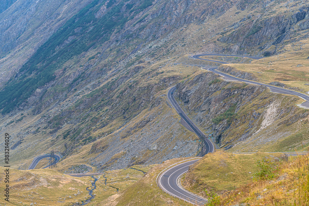Transfagarasan road in Romania - curved amazing motorway through the mountains from Transylvania in a cloudy day with spectacular sky