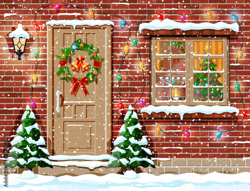 Christmas facade decoration. Entrance to suburban house decorated with wreath, bells, garland lights. Holiday greetings. Snowflakes, snowdrifts. New year and xmas celebration. Flat vector illustration