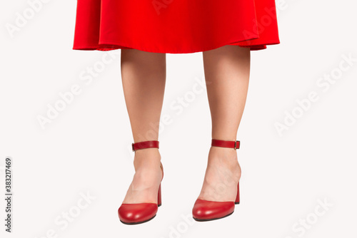 Woman in red dress and in retro red sandals on heels.