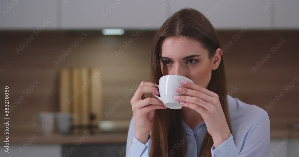 Young beautiful girl sitting in the kitchen and drinking coffee, portrait, day off at home. Young beautiful girl sitting in the kitchen and drinking coffee, portrait, day off at home.